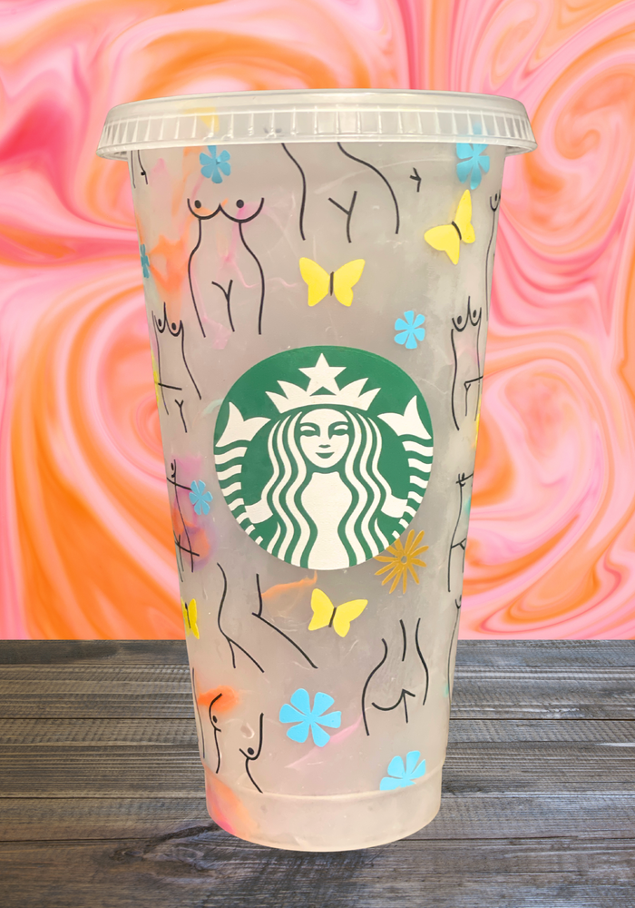 A 16 oz BPA-free Starbucks-compatible reusable cold cup featuring a vinyl wrap with minimalist female body line art, butterflies, and floral accents. Includes a clear lid and reusable straw, perfect for empowering iced coffee enthusiasts.