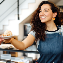 Load image into Gallery viewer, A barista wearing “Luke’s Diner” earrings
