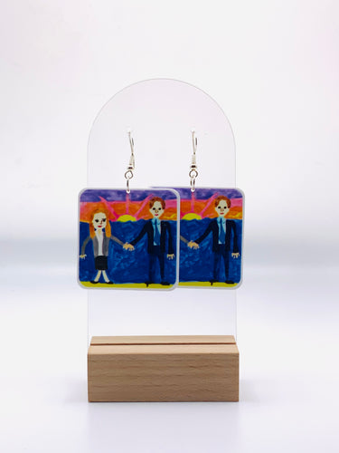 Earrings featuring a replica of Michael Scott's unforgettable, quirky wedding gift to Jim and Pam from 'The Office'. An amateur wedding painting of Jim and Pam painting by Michael.