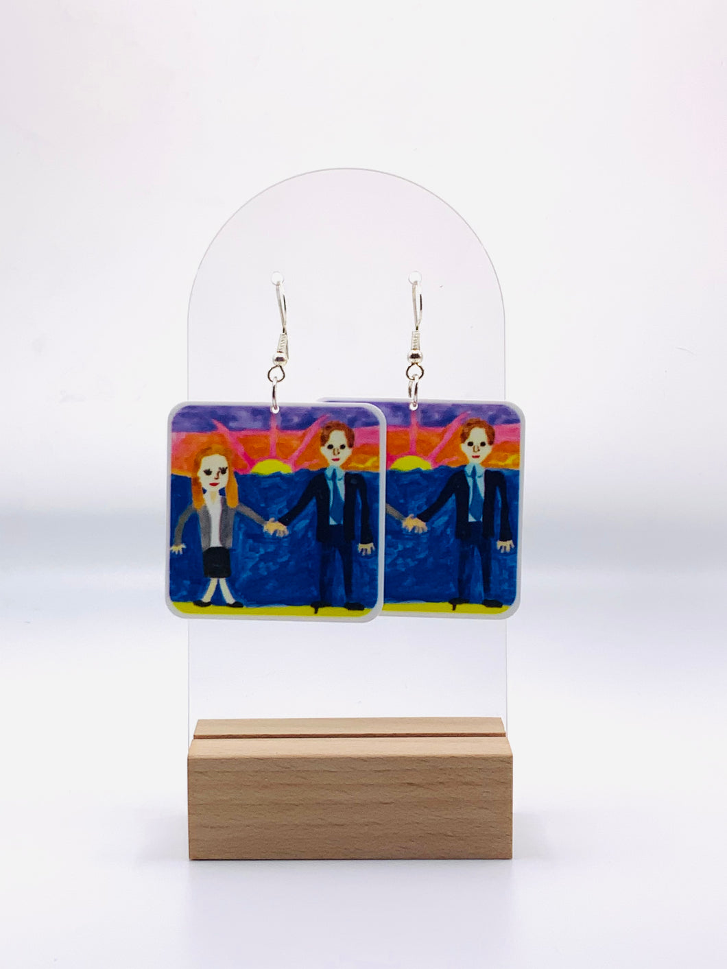 Earrings featuring a replica of Michael Scott's unforgettable, quirky wedding gift to Jim and Pam from 'The Office'. An amateur wedding painting of Jim and Pam painting by Michael.