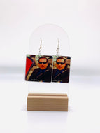 Earrings featuring Michael Scott driving in a red car with the caption 
