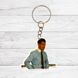 A keychain on a white background featuring Schmidt from New Girl yelling “I’m as mad as a dad in traffic” 