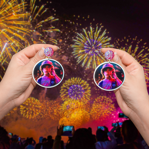 Holding up earrings featuring Dustin during the firework scene from Stranger Things during fireworks