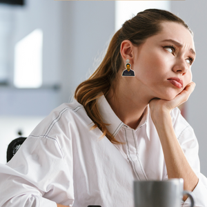 A woman bored at work wearing earrings featuring Ron Swanson from Parks and Recreation with the quote "This is my hell."