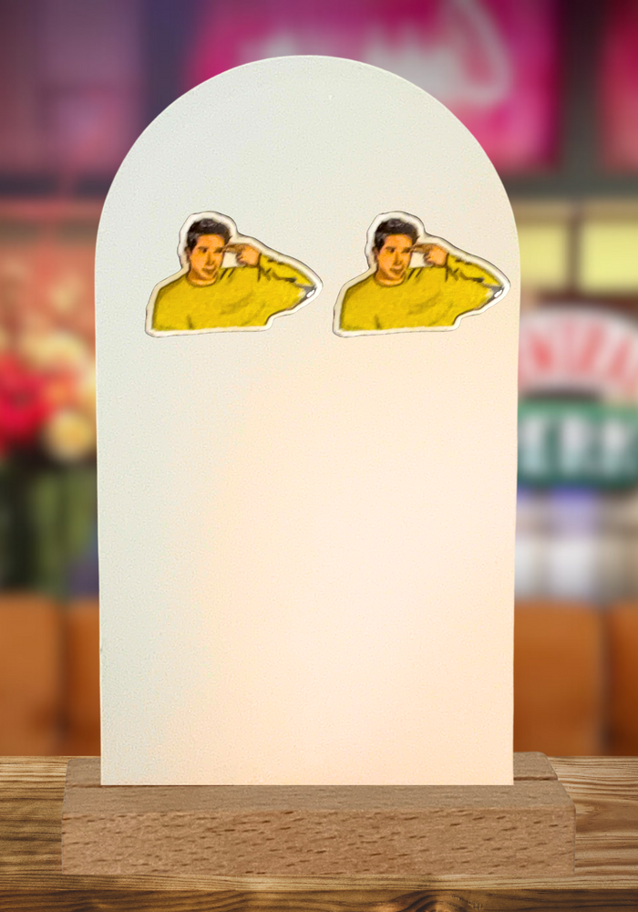 Quirky ‘Ross Geller Unagi’ earrings featuring the iconic Friends character’s gesture for humor and nostalgia featuring a Central Perk background