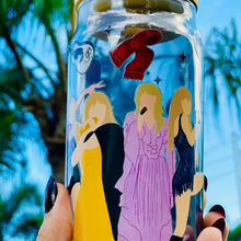 Load image into Gallery viewer, BPA-free 20 oz glass cup featuring Taylor Swift&#39;s iconic eras tour outfits in a vibrant UVDTF wrap design, complete with a bamboo lid and glass straw.
