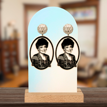 Load image into Gallery viewer, Earrings featuring a smiling Blanche from Golden Girls with the snarky saying &quot;Eat Dirt and Die, Trash&quot; underneath
