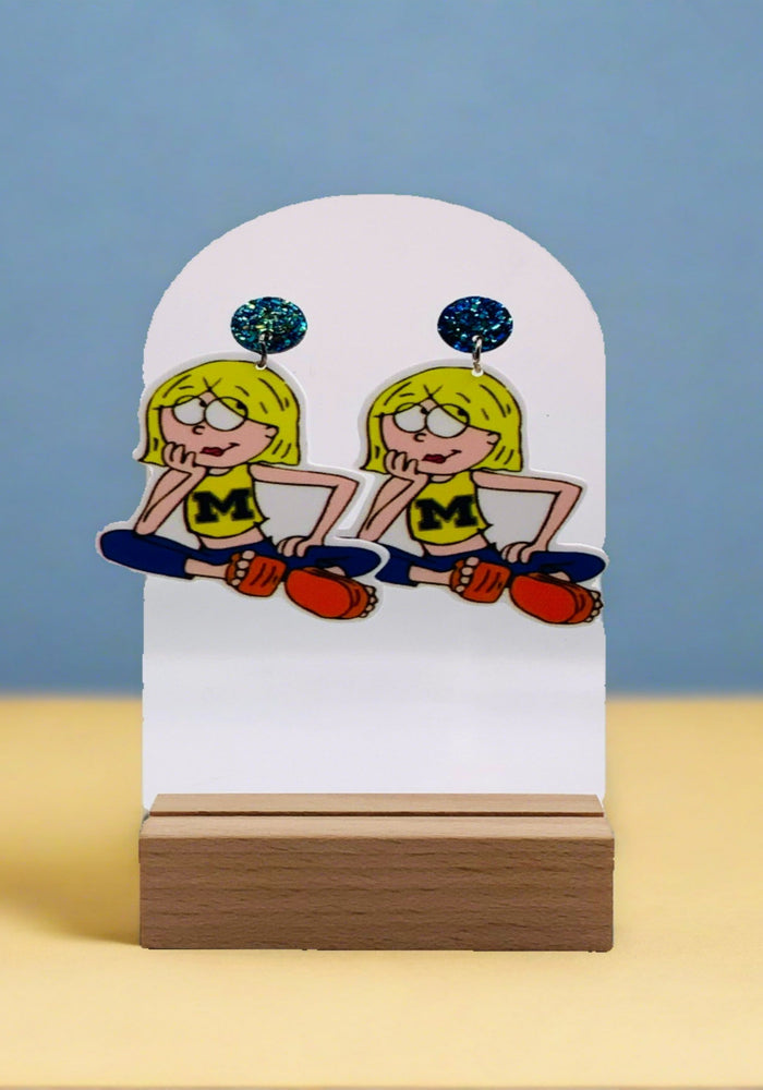 Cartoon Lizzie McGuire decked out in a Michigan Wolverines t-shirt on playful earrings, merging Lizzie McGuire nostalgia with Michigan football fandom