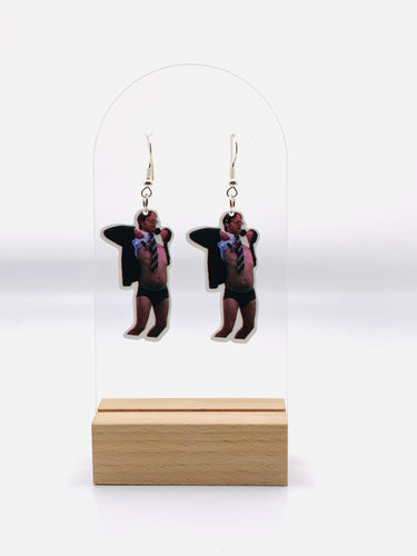 Earrings featuring a detailed print of Dwight Schrute’s surprised face and untucked shirt from “The Office,” capturing the humor of the iconic “No Wire” scene