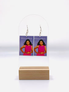 Earrings inspired by Kelly Kapoor's iconic 'Business Bitch' moment from The Office. A fictional purple book cover featuring a photo of Kelly with the title "Business Bitch"