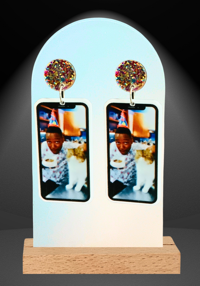 Earrings featuring an iPhone with a birthday selfie of Winston and Ferguson the cat from New Girl