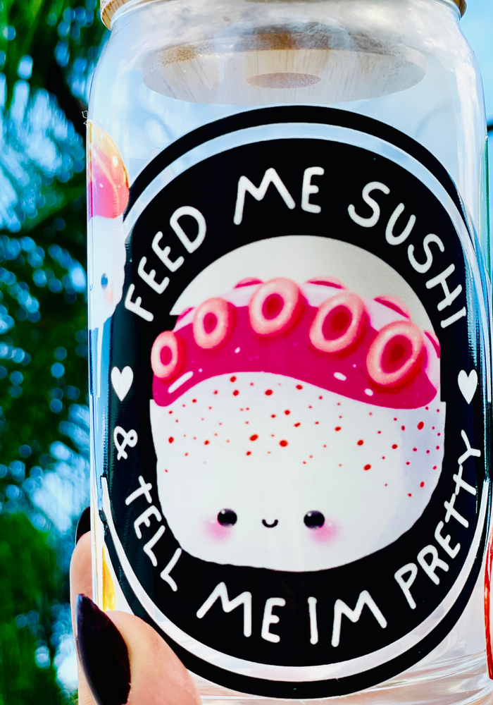 Feed Me Sushi and Tell Me I'm Pretty 16 oz glass cup with bamboo lid and reusable glass straw, featuring a sushi-themed design with colorful rolls, soy sauce, and chopsticks.