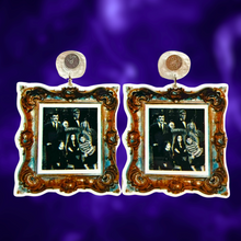 Load image into Gallery viewer, Earrings with a gold frame featuring a black and white photo of the Addams Family, perfect for spooky and gothic fashion lover
