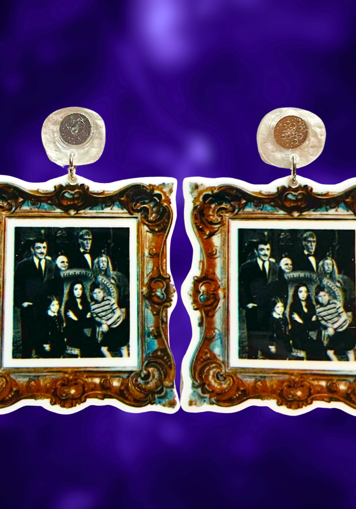 Earrings with a gold frame featuring a black and white photo of the Addams Family, perfect for spooky and gothic fashion lover