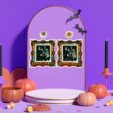 Load image into Gallery viewer, Purple jewelry backdrop with earrings with a gold frame featuring a black and white photo of the Addams Family, perfect for spooky and gothic fashion lover
