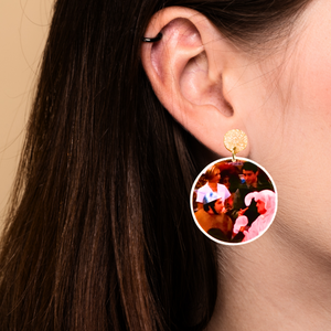 Earrings featuring Ross and Chandler from FRIENDS arm wrestling, dressed in a pink bunny costume and a Sputnik costume.