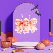 Load image into Gallery viewer, A purple jewelry background featuring pink coquette bow earrings with adorable ghost patterns, perfect for adding a cute and spooky twist to Halloween fashion.
