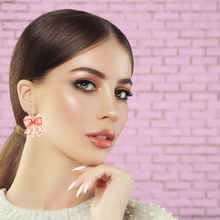 Load image into Gallery viewer, A beautiful model wearing pink coquette ghost earrings
