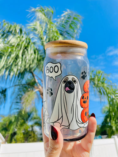 A 16 oz glass cup with a Halloween design of dogs dressed as ghosts, featuring “boo” speech bubbles, paw prints, a bamboo lid, and a reusable glass straw.