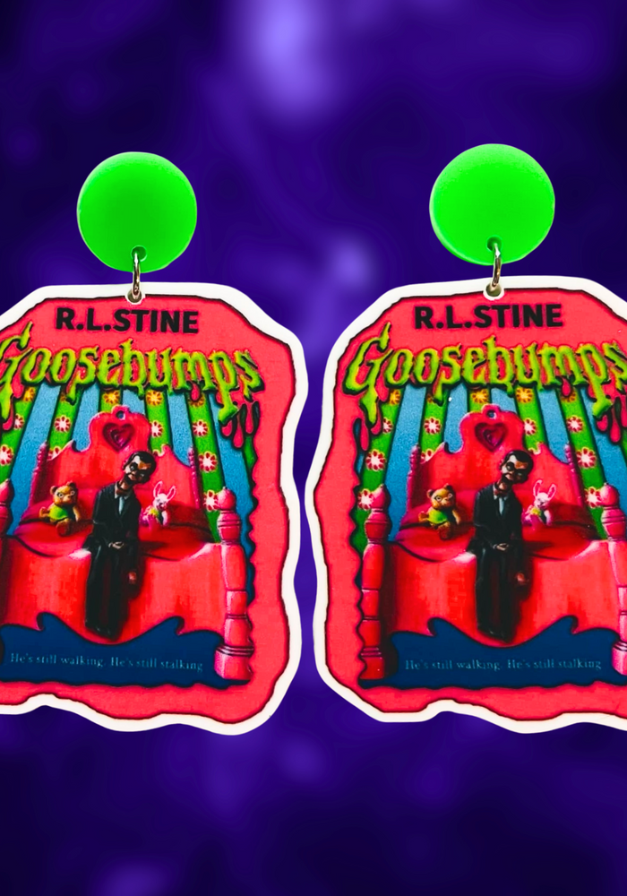 Goosebumps 'Living Dummy' book cover earrings on a purple background, perfect for a fun and nostalgic accessory for 90s horror fans