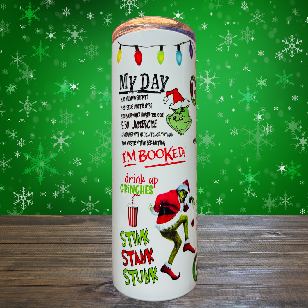 A 20 oz stainless steel insulated tumbler featuring a fun pattern with iconic Grinch quotes. Comes with a clear lid, metal straw, and straw cleaner, perfect for hot and cold drinks. Discounted due to slight ghosting in three small spots.