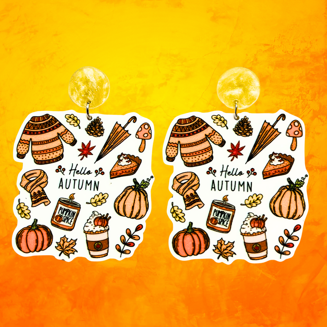 Orange background with earrings with the phrase 'Hello Autumn' featuring doodles of a scarf, sweater, pumpkin, leaves, coffee, candles, and pumpkin pie, perfect for cozy fall enthusiasts