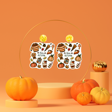 Load image into Gallery viewer, Orange stand with earrings with the phrase &#39;Hello Autumn&#39; featuring doodles of a scarf, sweater, pumpkin, leaves, coffee, candles, and pumpkin pie, perfect for cozy fall enthusiasts
