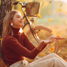 Load image into Gallery viewer, A woman sitting in front of a tree with falling autumn leaves, wearing earrings with the phrase &#39;Hello Autumn&#39; featuring doodles of a scarf, sweater, pumpkin, leaves, coffee, candles, and pumpkin pie, perfect for cozy fall enthusiasts 
