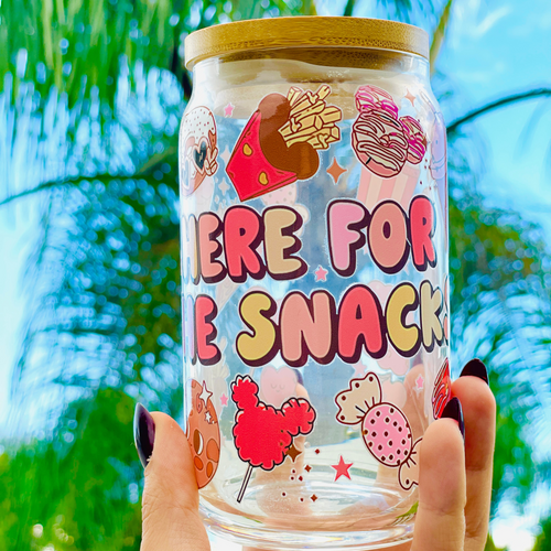 A 16oz BPA-free glass cup featuring a colorful UVDTF wrap with Disney-inspired snacks, including churros, Mickey pretzels, and ice cream. Comes with a bamboo lid and reusable glass straw, perfect for Disney and snack lovers.