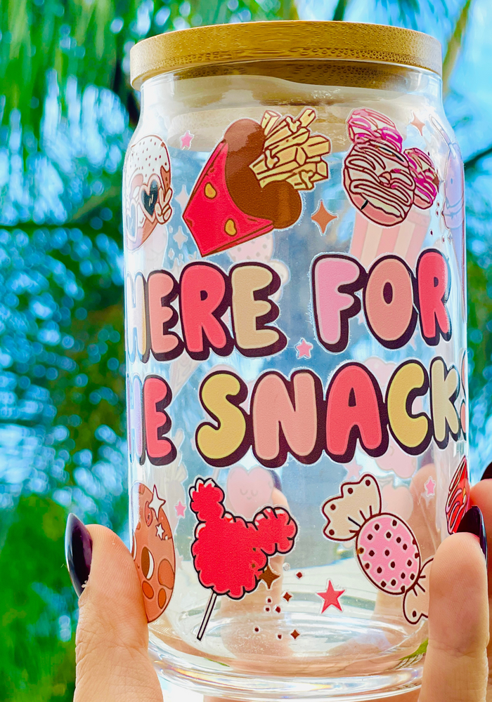 A 16oz BPA-free glass cup featuring a colorful UVDTF wrap with Disney-inspired snacks, including churros, Mickey pretzels, and ice cream. Comes with a bamboo lid and reusable glass straw, perfect for Disney and snack lovers.