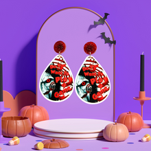 Load image into Gallery viewer, Earrings featuring a cute cartoon version of Jigsaw with the phrase &quot;Do You Want to Play a Game?&quot; from the movie Saw, perfect for horror movie fans and Halloween accessory lovers.
