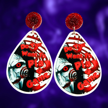 Load image into Gallery viewer, Earrings featuring a cute cartoon version of Jigsaw with the phrase &quot;Do You Want to Play a Game?&quot; from the movie Saw, perfect for horror movie fans and Halloween accessory lovers.
