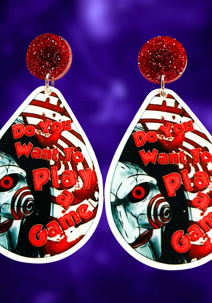 Earrings featuring a cute cartoon version of Jigsaw with the phrase 