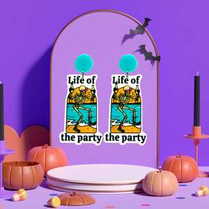 Purple jewelry backdrop with earrings featuring a skeleton double-fisting beers on the beach with the text 'Life of the Party,' perfect for fans of funny Halloween accessories