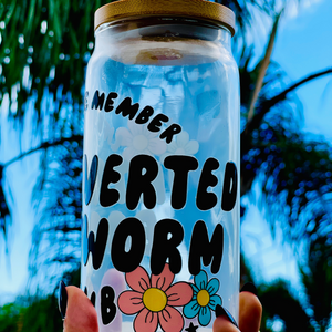 A 20oz BPA-free glass cup with a floral UVDTF wrap featuring the text "Lifetime Member: Introverted Bookworm Club," paired with a bamboo lid and glass straw. Ideal for bookworms and iced coffee enthusiasts.