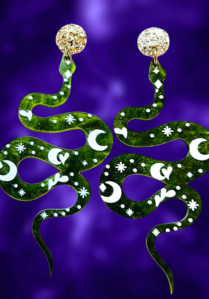 Earrings featuring a mystic green snake on marbled acrylic with celestial markings, perfect for fans of unique Halloween accessories.
