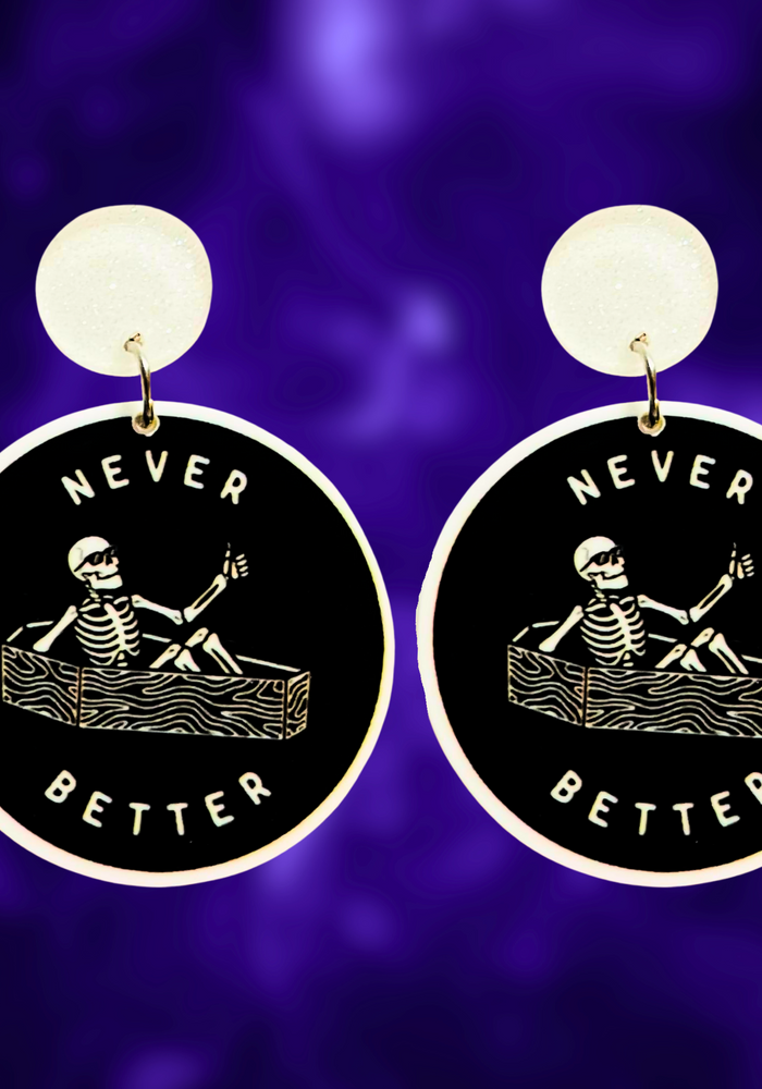 Earrings featuring a skeleton sitting in a coffin giving a thumbs up with the phrase 'Never Better,' perfect for edgy Halloween accessories