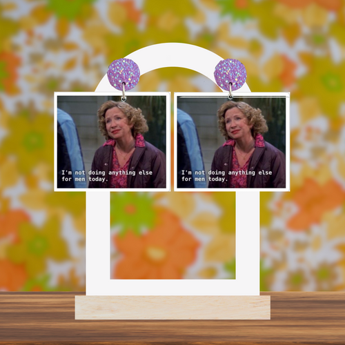 Kitty Forman earrings saying 