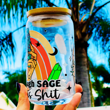 Load image into Gallery viewer, A 16oz BPA-free glass cup with a UVDTF wrap featuring a retro rainbow, celestial accents, and a smudge stick design. Includes a bamboo lid and reusable glass straw, perfect for iced drinks.
