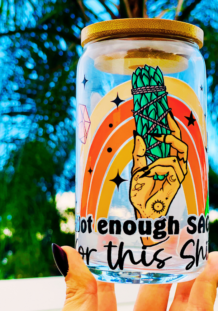 A 16oz BPA-free glass cup with a UVDTF wrap featuring a retro rainbow, celestial accents, and a smudge stick design. Includes a bamboo lid and reusable glass straw, perfect for iced drinks.