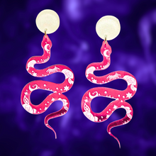 Load image into Gallery viewer, Pink earrings with a mystical snake design and celestial markings, perfect for adding a magical touch to your Halloween style
