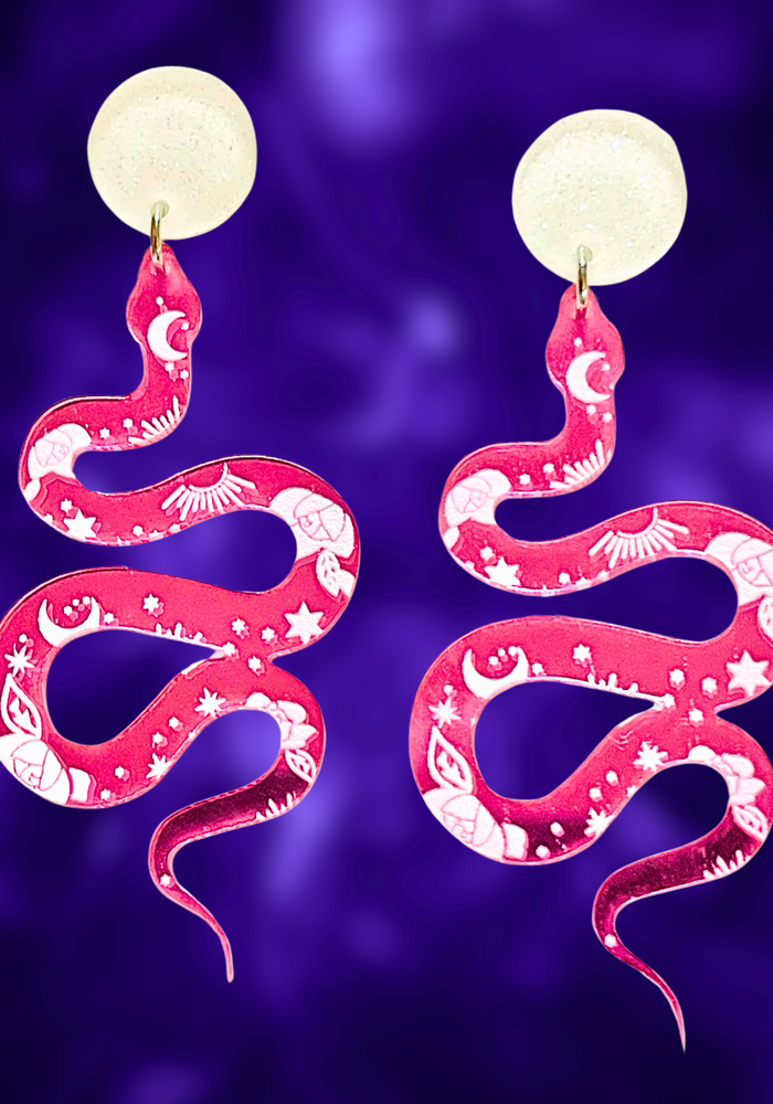 Pink earrings with a mystical snake design and celestial markings, perfect for adding a magical touch to your Halloween style