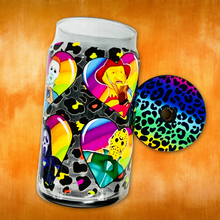 Load image into Gallery viewer, A 16 oz glass cup with a colorful design of rainbow hearts featuring horror movie icons like Michael Myers and Freddy Krueger, paired with a rainbow leopard bamboo lid and reusable glass straw.
