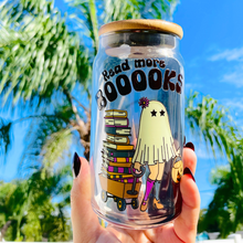 Load image into Gallery viewer, A 16 oz glass cup featuring a cute ghost design pulling a wagon full of books with the text &quot;Read More BOOks.&quot; Includes a bamboo lid decorated with tiny ghosts and a reusable glass straw, ideal for book lovers.
