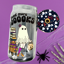 Load image into Gallery viewer, A 16 oz glass cup featuring a cute ghost design pulling a wagon full of books with the text &quot;Read More BOOks.&quot; Includes a bamboo lid decorated with tiny ghosts and a reusable glass straw, ideal for book lovers.
