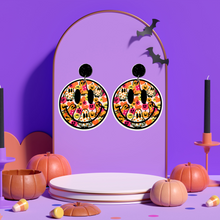 Load image into Gallery viewer, A purple earring stand displaying smiley face earrings filled with colorful ghosts and flowers, perfect for a fun and lighthearted Halloween look
