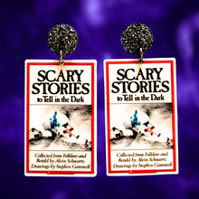 Load image into Gallery viewer, Earrings featuring the Scary Stories to Tell in the Dark book cover, perfect for nostalgic 90s kids and horror fans.
