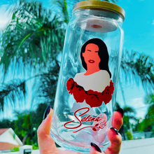 Load image into Gallery viewer, A 20 oz glass cup featuring iconic Selena Quintanilla designs with a bamboo lid and reusable glass straw. Perfect for fans of the late Tejano music legend.
