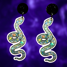 Load image into Gallery viewer, A pair of sparkly silver snake earrings, perfect for adding a glamorous and mystical touch to your Halloween fashion.
