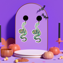 Load image into Gallery viewer, Purple jewelry stand with a pair of sparkly silver snake earrings, perfect for adding a glamorous and mystical touch to your Halloween fashion.
